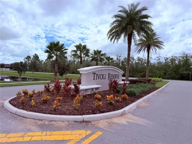 a view of entryway and kitchen with wooden floor