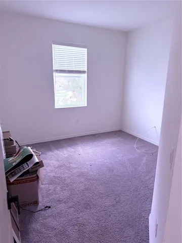 a view of a room with wooden floor and furniture