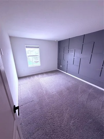 a view of a big room with carpet