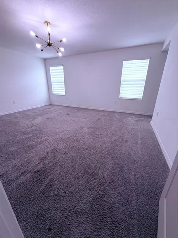 a view of room with furniture and wooden floor