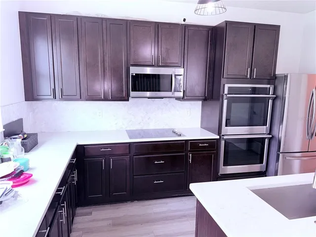 a kitchen with a sink and wooden cabinets
