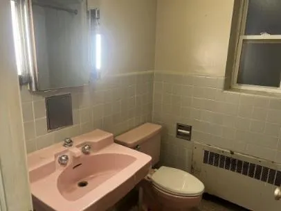 a bathroom with a sink a toilet and mirror