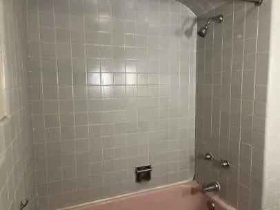a bathroom with a shower and a shower
