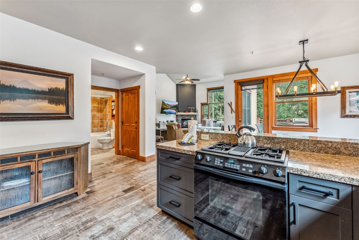 231 Hawk Circle, Unit 2324 Keystone, CO 80435 - Photo 11 of 48 a kitchen that has a stove and a wooden cabinets