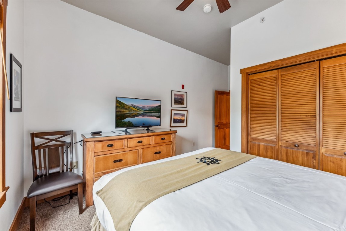 231 Hawk Circle, Unit 2324 Keystone, CO 80435 - Photo 23 of 48 a bedroom with a bed and wooden floor