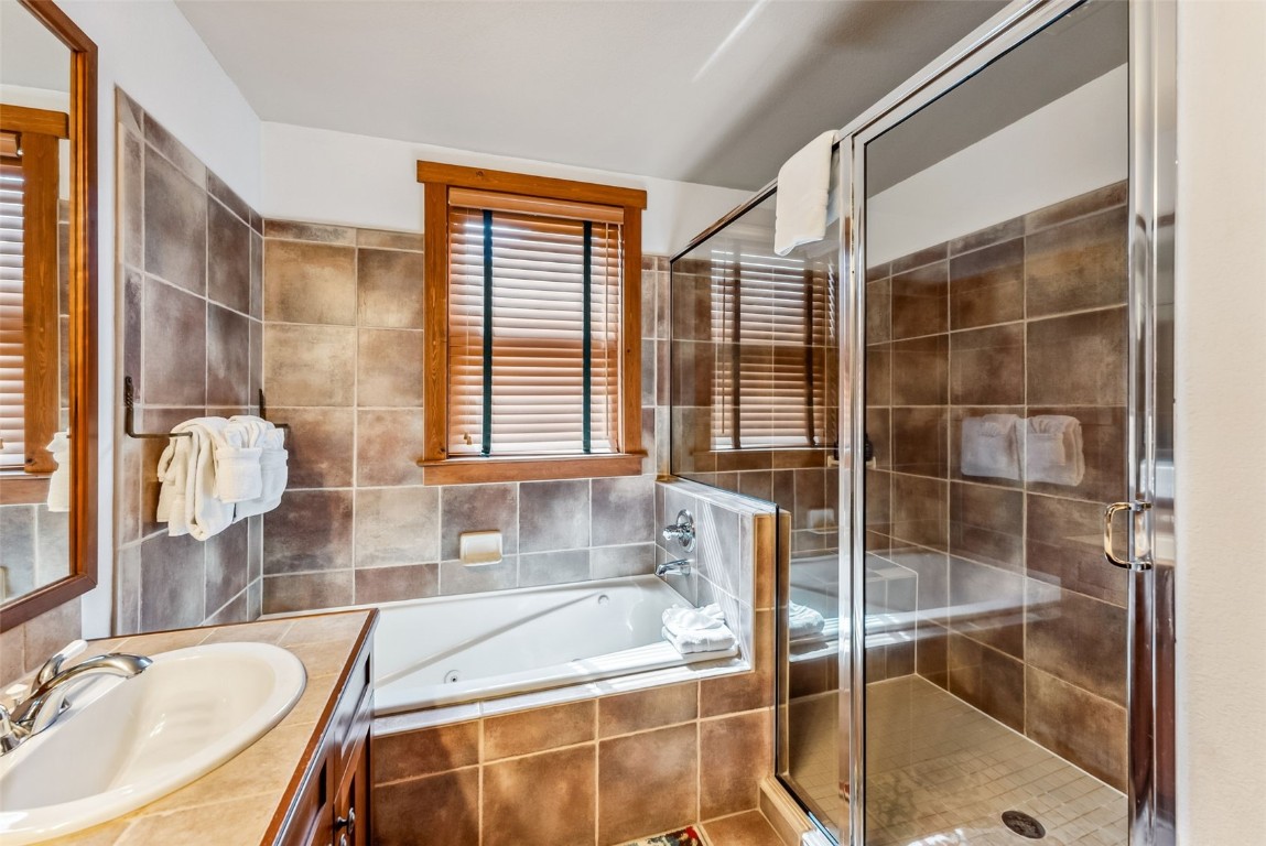 231 Hawk Circle, Unit 2324 Keystone, CO 80435 - Photo 27 of 48 a bathroom with a granite countertop sink and a bathtub