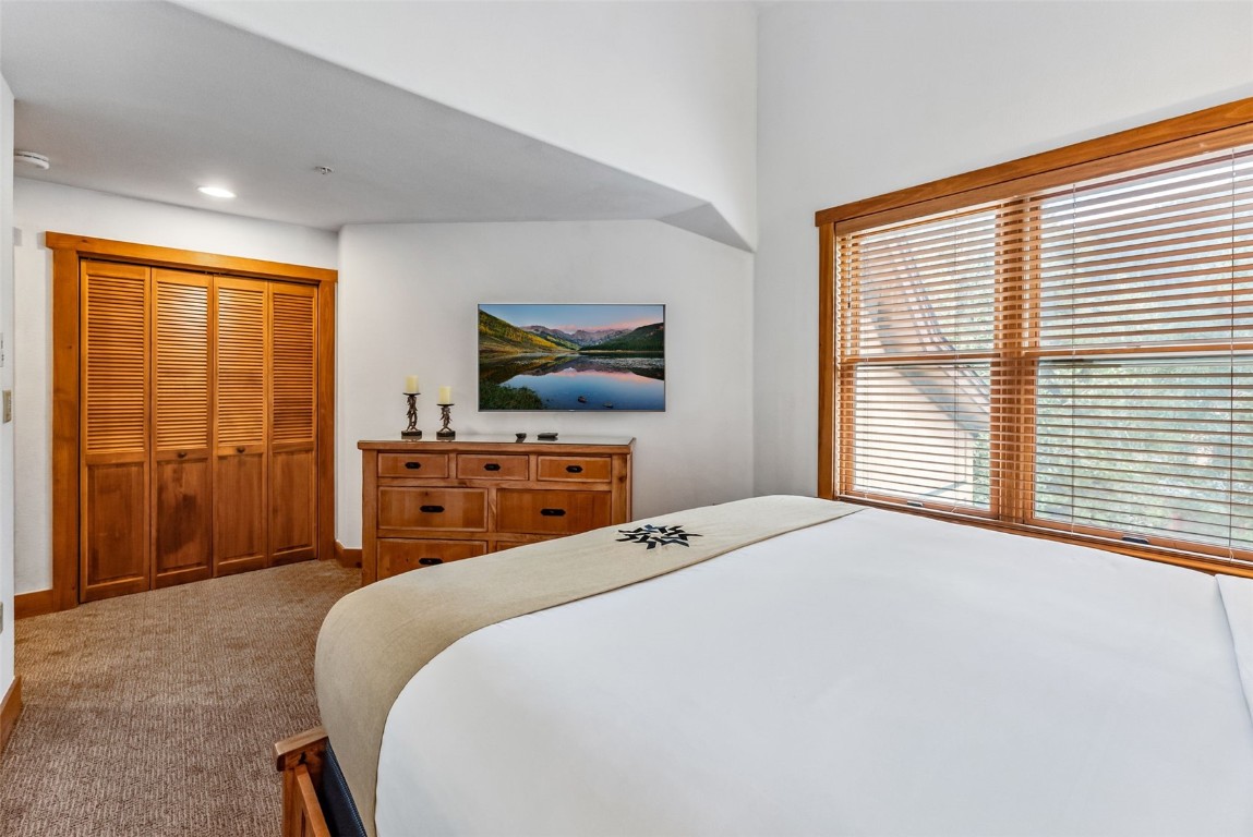 231 Hawk Circle, Unit 2324 Keystone, CO 80435 - Photo 30 of 48 a bedroom with a bed and a flat screen tv