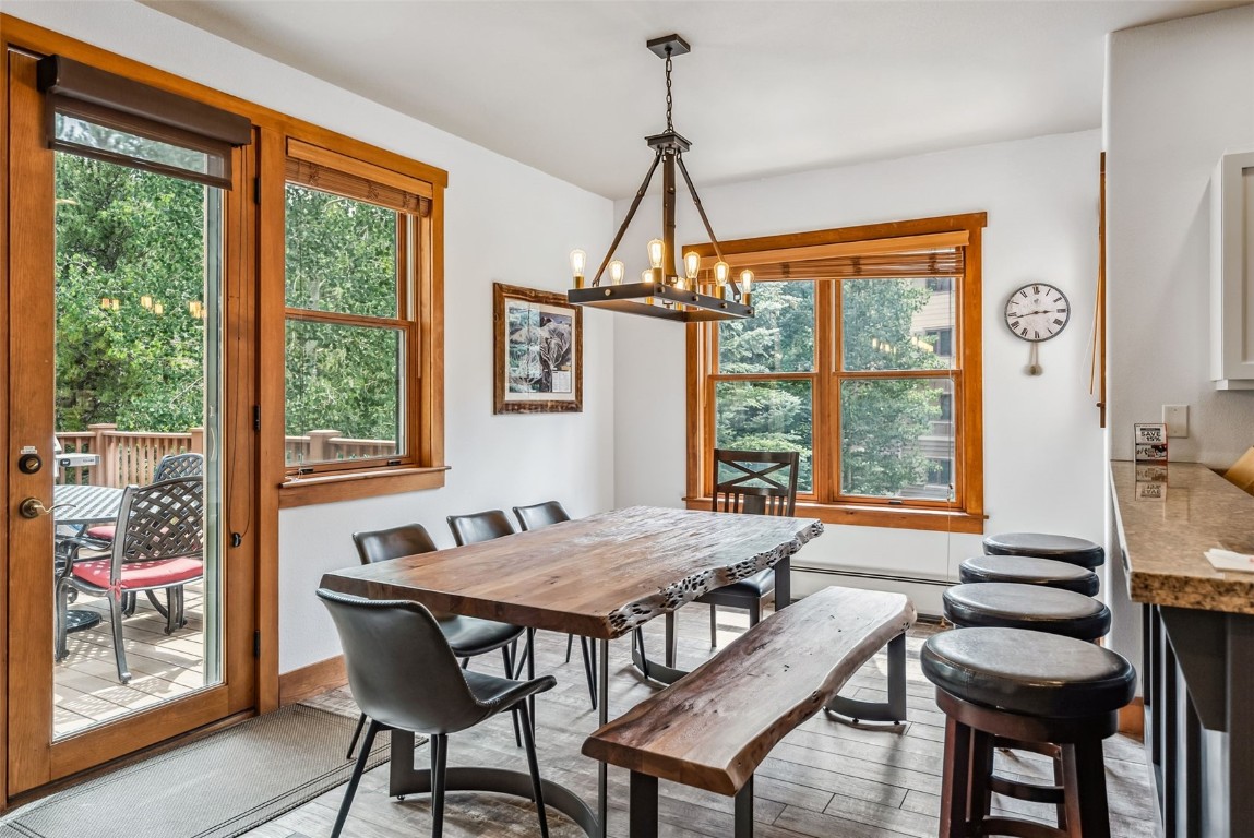 231 Hawk Circle, Unit 2324 Keystone, CO 80435 - Photo 9 of 48 a view of a dining room with furniture large windows and wooden floor