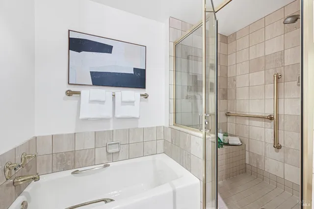 a bathroom with a bathtub and a shower