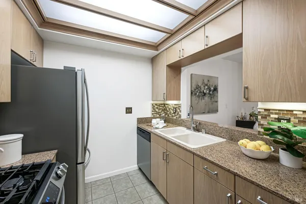 a spacious bathroom with a granite countertop sink and a mirror