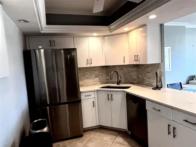 a kitchen with a refrigerator and a sink