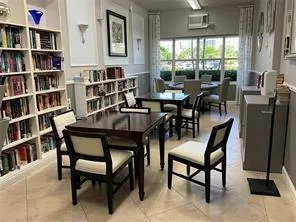 a view of a patio with table and chairs and potted plants
