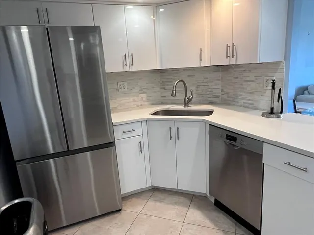 a kitchen with stainless steel appliances a refrigerator and a sink