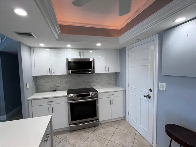 a kitchen with a sink appliances and cabinets