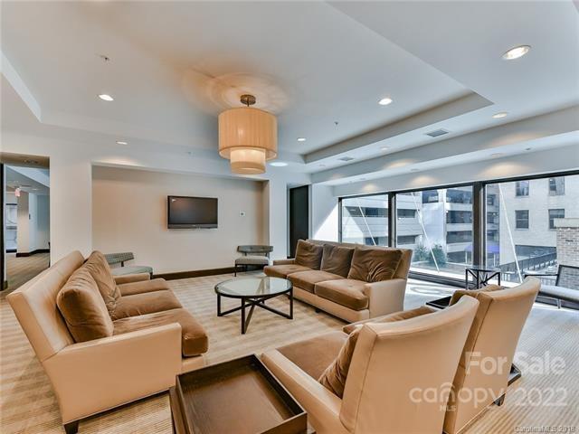 230 South Tryon Street, Unit 1109 Charlotte, NC 28202 - Photo 12 of 17 a living room with furniture and a large window