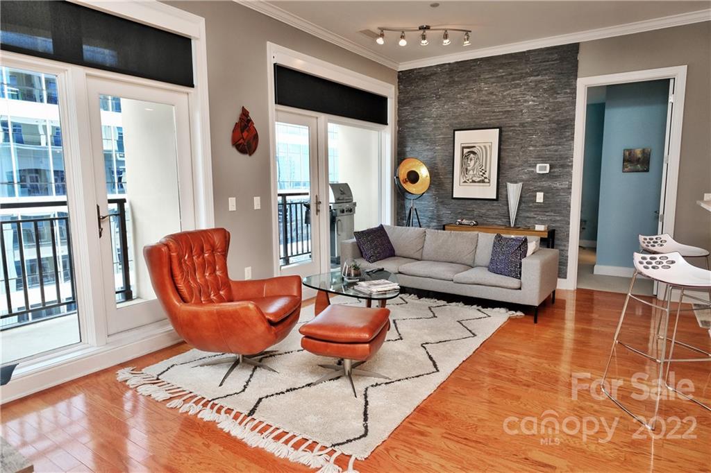 230 South Tryon Street, Unit 1109 Charlotte, NC 28202 - Photo 5 of 17 a living room with furniture and a table