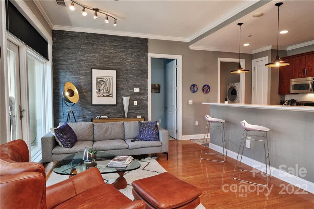 230 South Tryon Street, Unit 1109 Charlotte, NC 28202 - Photo 6 of 17 a living room with furniture and a large window