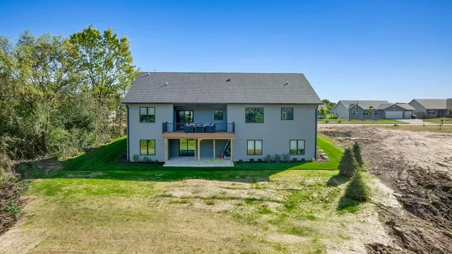 a kitchen with stainless steel appliances granite countertop a sink and wooden cabinets
