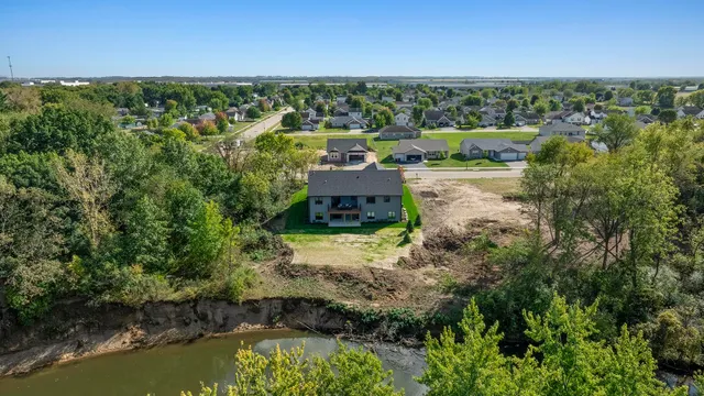 a kitchen with stainless steel appliances granite countertop a sink a stove and a wooden floors