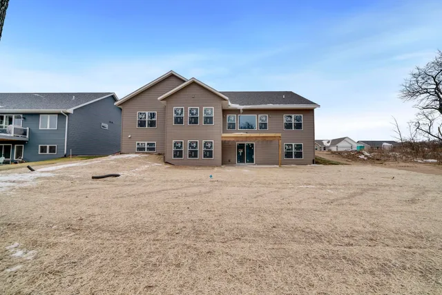 a kitchen with stainless steel appliances granite countertop a sink a stove and a wooden floors