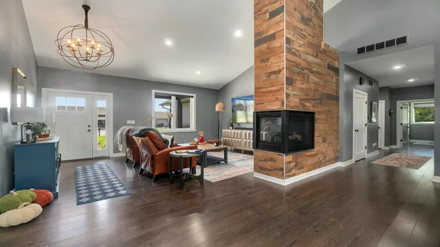 a living room with furniture and wooden floor