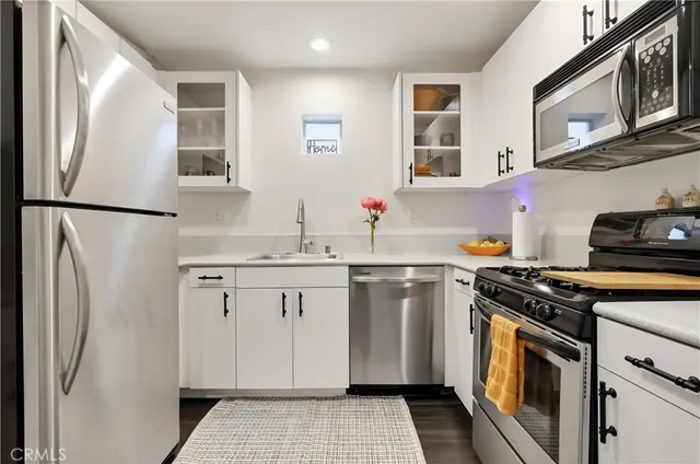 a kitchen with a refrigerator and a sink
