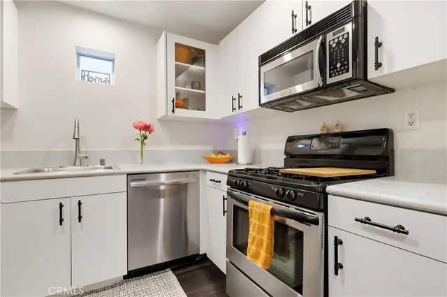 a view of a kitchen with a refrigerator and a view of bathroom