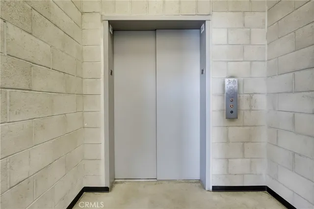 a living room with stainless steel appliances kitchen island furniture and a kitchen view
