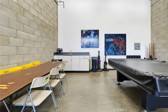 a patio with a table and chairs under an umbrella
