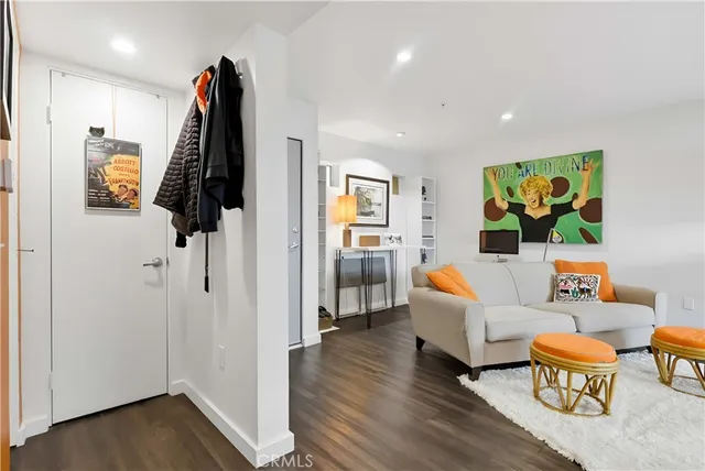 a view of a workspace with furniture and wooden floor