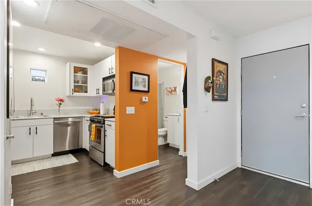 a kitchen with appliances a refrigerator and a sink