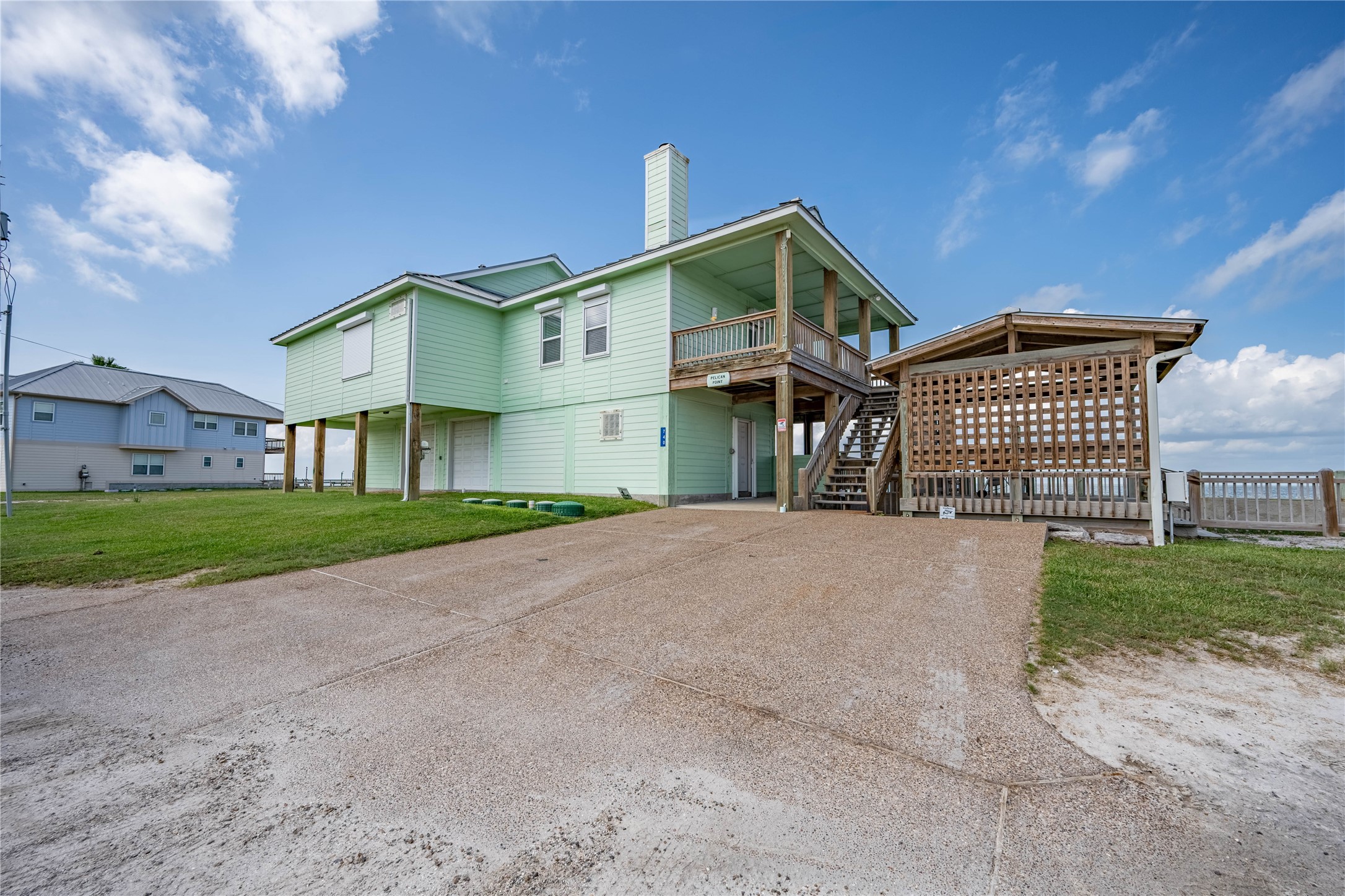 740 Copano Cove Road Rockport, TX 78382 - Photo 8 of 35 a front view of a house with a yard and garage