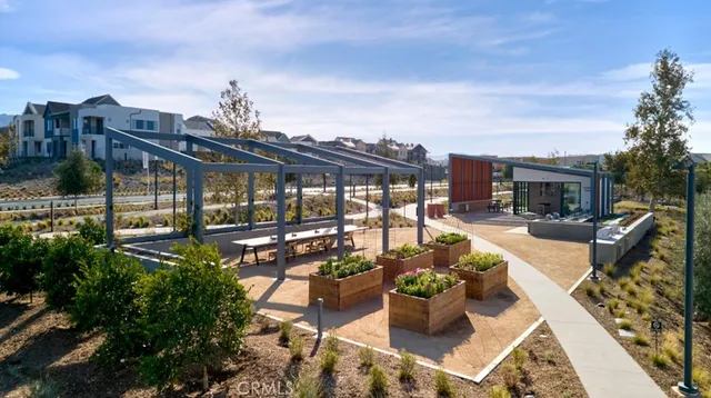 a view of a patio with couches table and chairs and potted plants