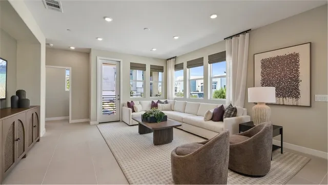 a living room with furniture and large windows