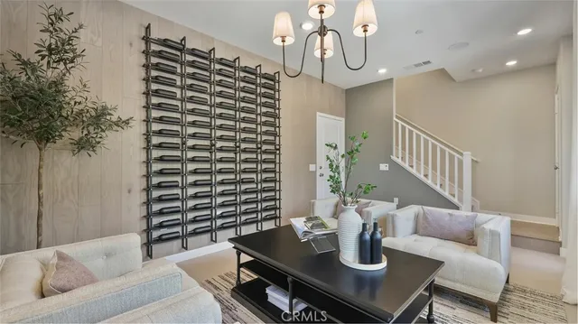 a living room with furniture and chandelier