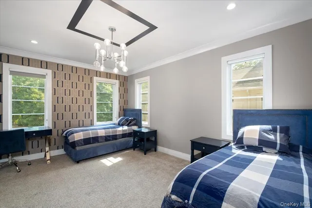 a spacious bedroom with a bed and a chandelier