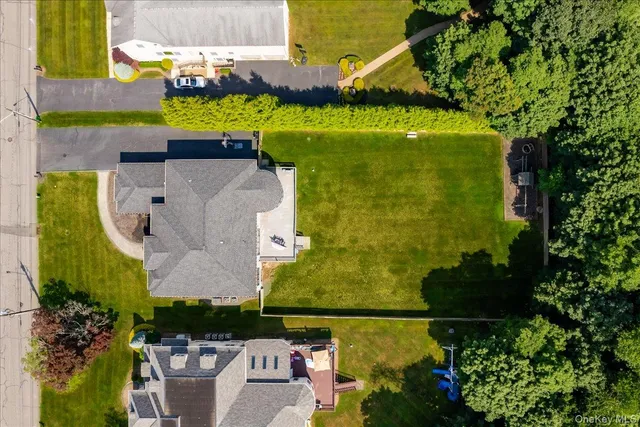 an aerial view of a house with a yard basket ball court and outdoor seating
