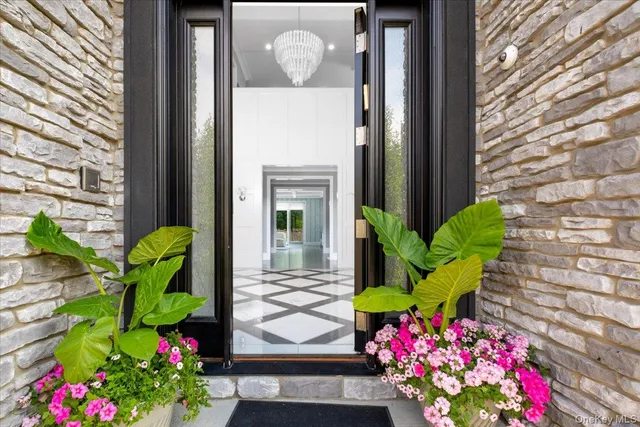 a vase of flowers sitting in front of a door