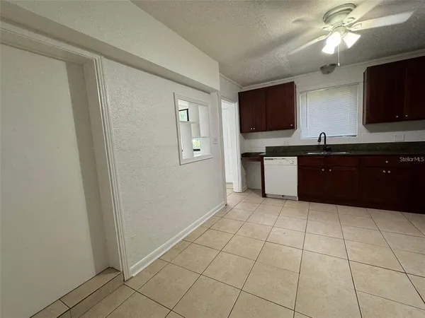 a large kitchen with granite countertop a sink and a stove top oven