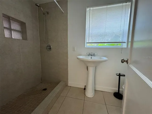 a bathroom with a sink a toilet and a shower
