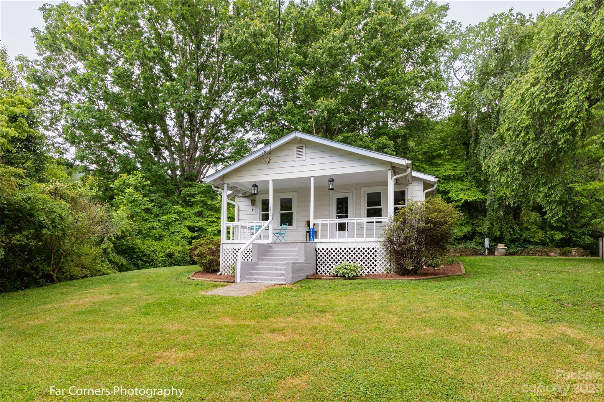 1335 Upper Brush Creek Road Fairview, NC 28730 - Photo 1 of 24 a front view of house with garden and trees