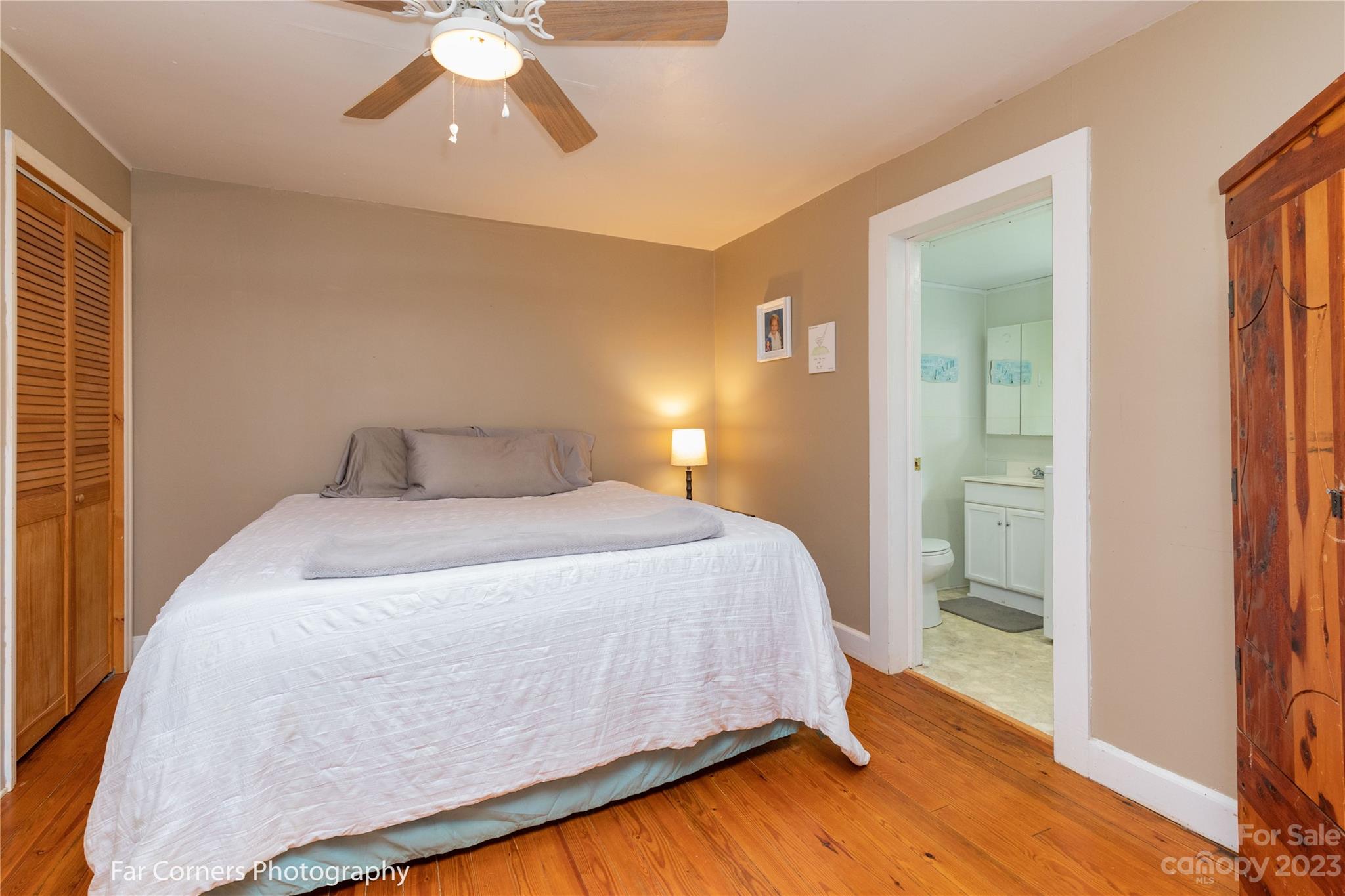 1335 Upper Brush Creek Road Fairview, NC 28730 - Photo 11 of 24 a bedroom with a bed and a chandelier