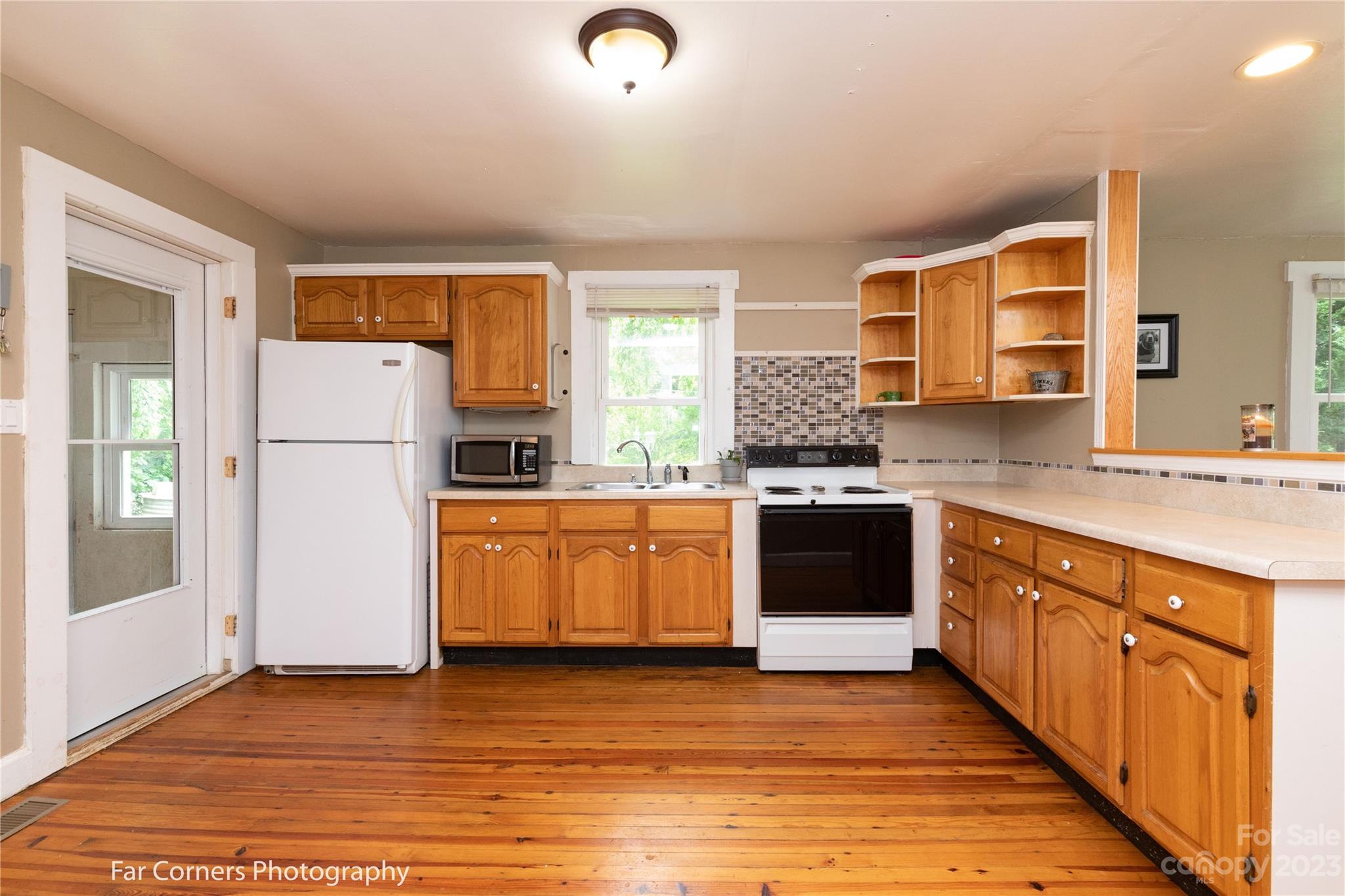 1335 Upper Brush Creek Road Fairview, NC 28730 - Photo 16 of 24 a kitchen with granite countertop a refrigerator stove top oven and sink