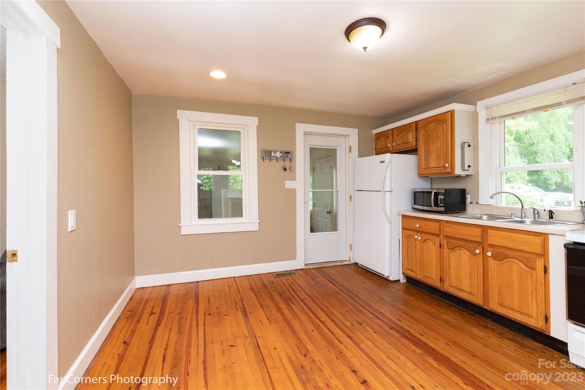 1335 Upper Brush Creek Road Fairview, NC 28730 - Photo 17 of 24 a open kitchen with kitchen island wooden floors and stainless steel appliances