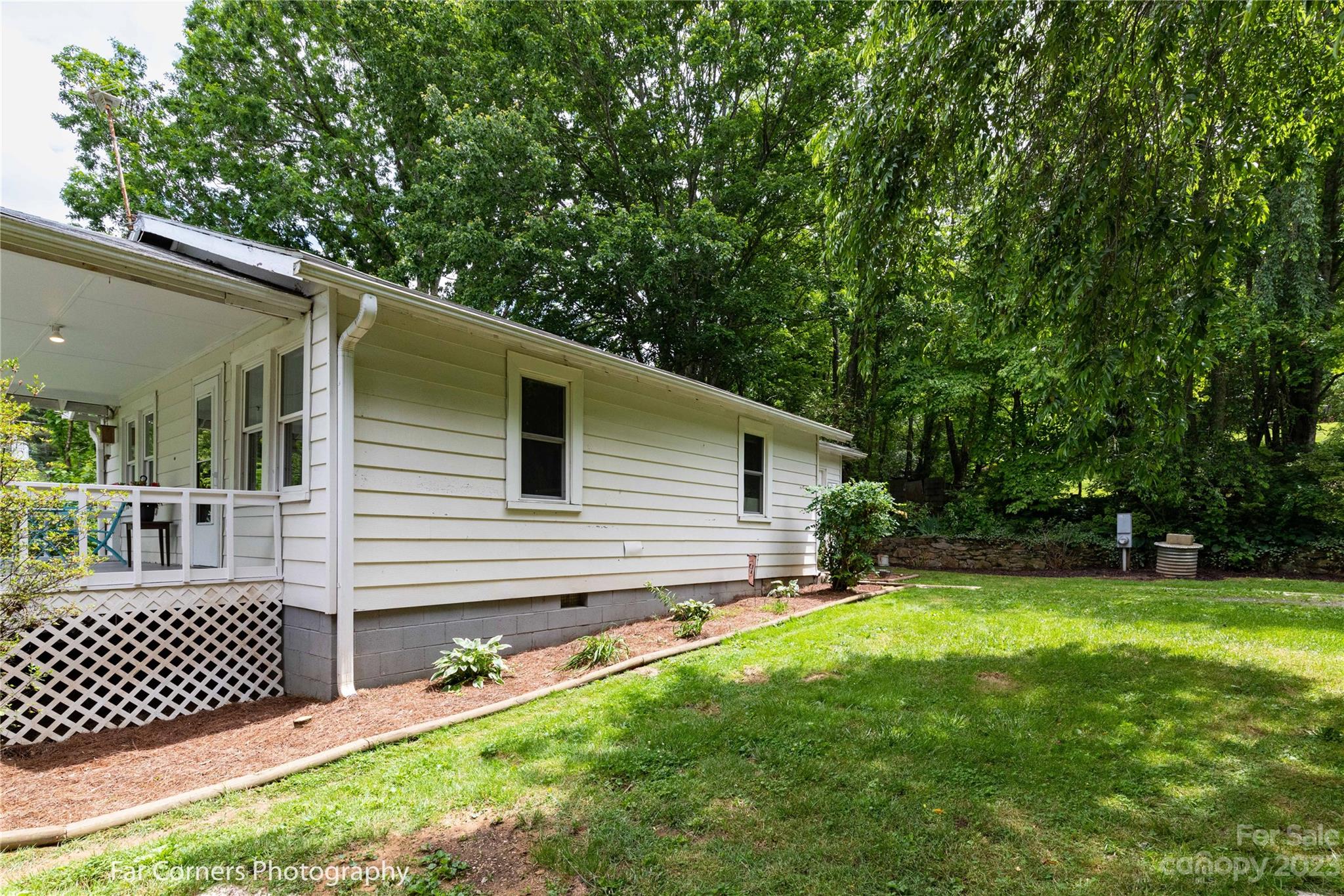 1335 Upper Brush Creek Road Fairview, NC 28730 - Photo 20 of 24 a backyard of a house with table and chairs