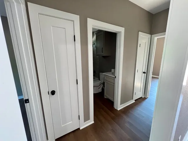 a view of a hallway with wooden floor