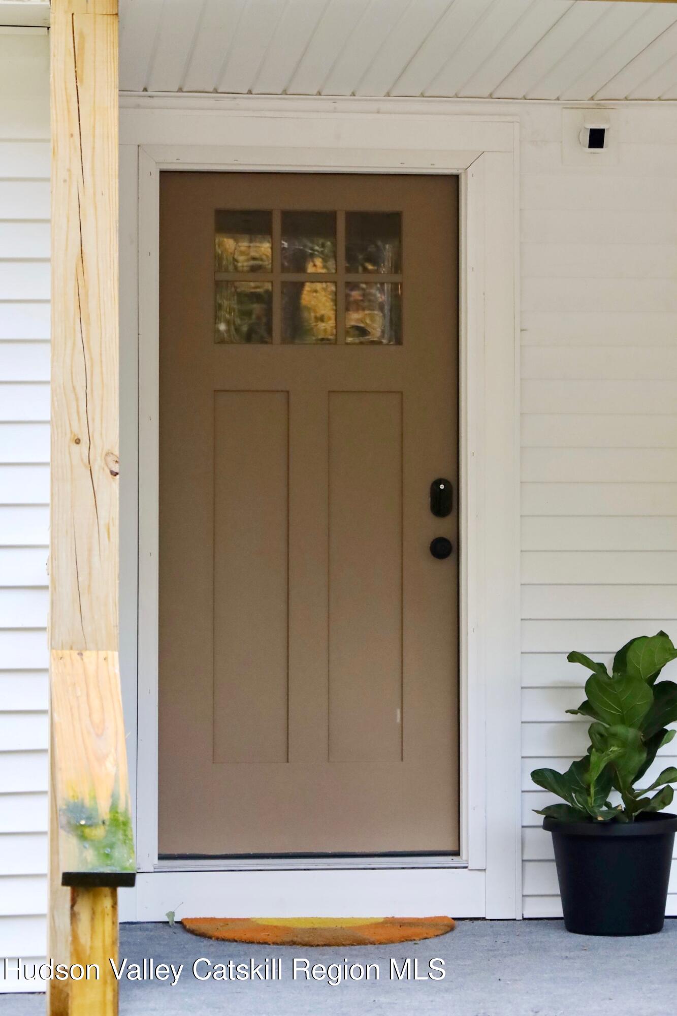 230 Potic Mountain Road Athens, NY 12414 - Photo 19 of 25 a potted plant sitting in front of a door