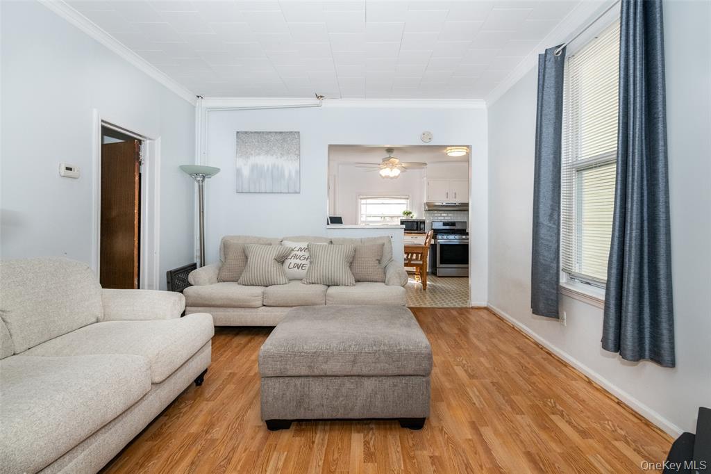 92 Washington Avenue, Unit 1 New Rochelle, NY 10801 - Photo 2 of 22 a living room with furniture and a large window