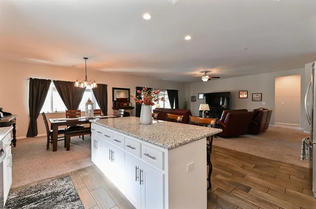 a living room with furniture and kitchen view