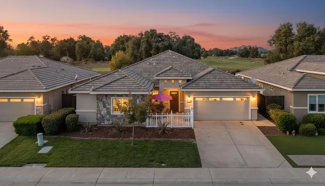a front view of house with yard and outdoor seating